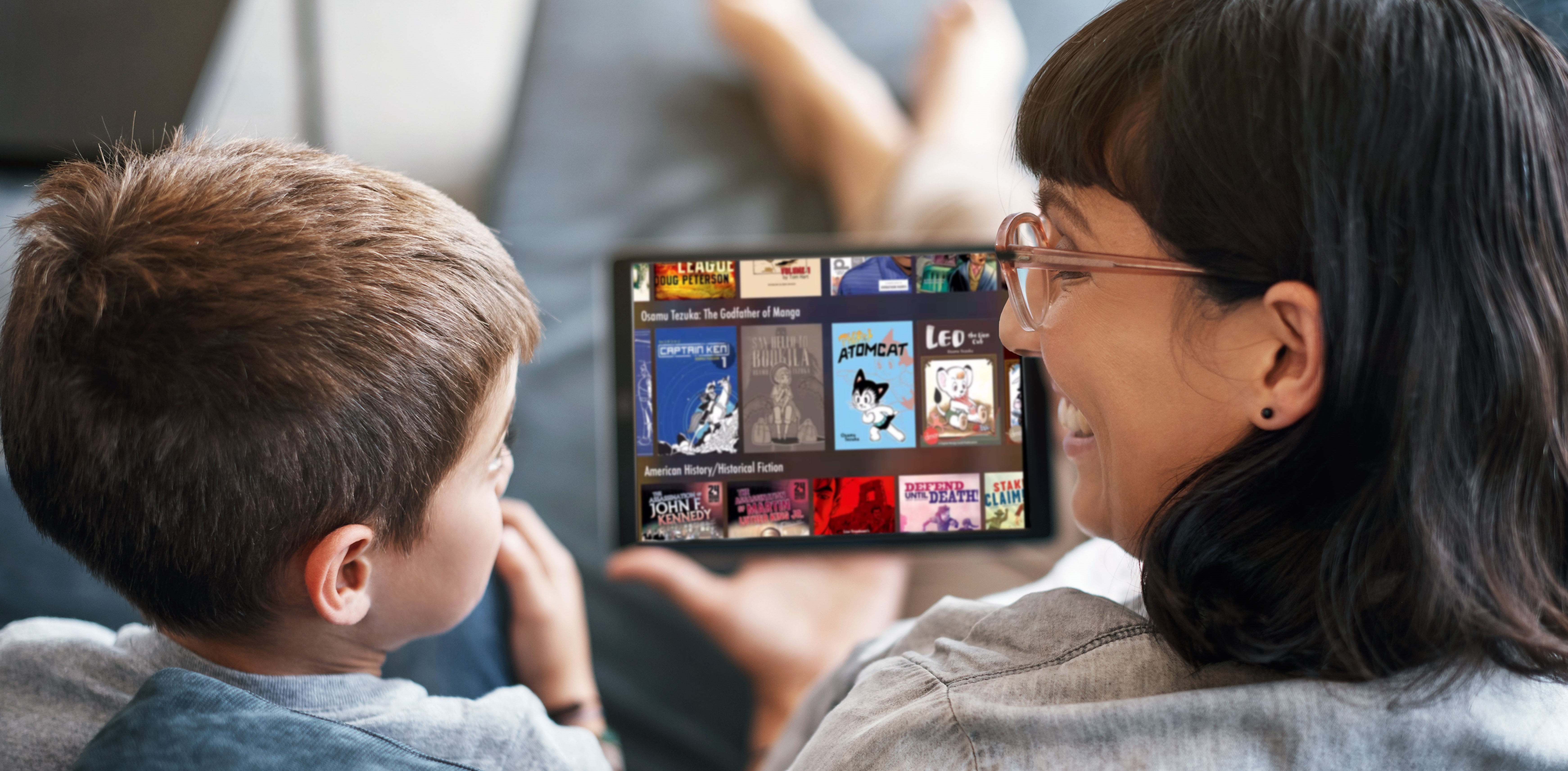 iStock-1166330599 mother son reading comics on tablet