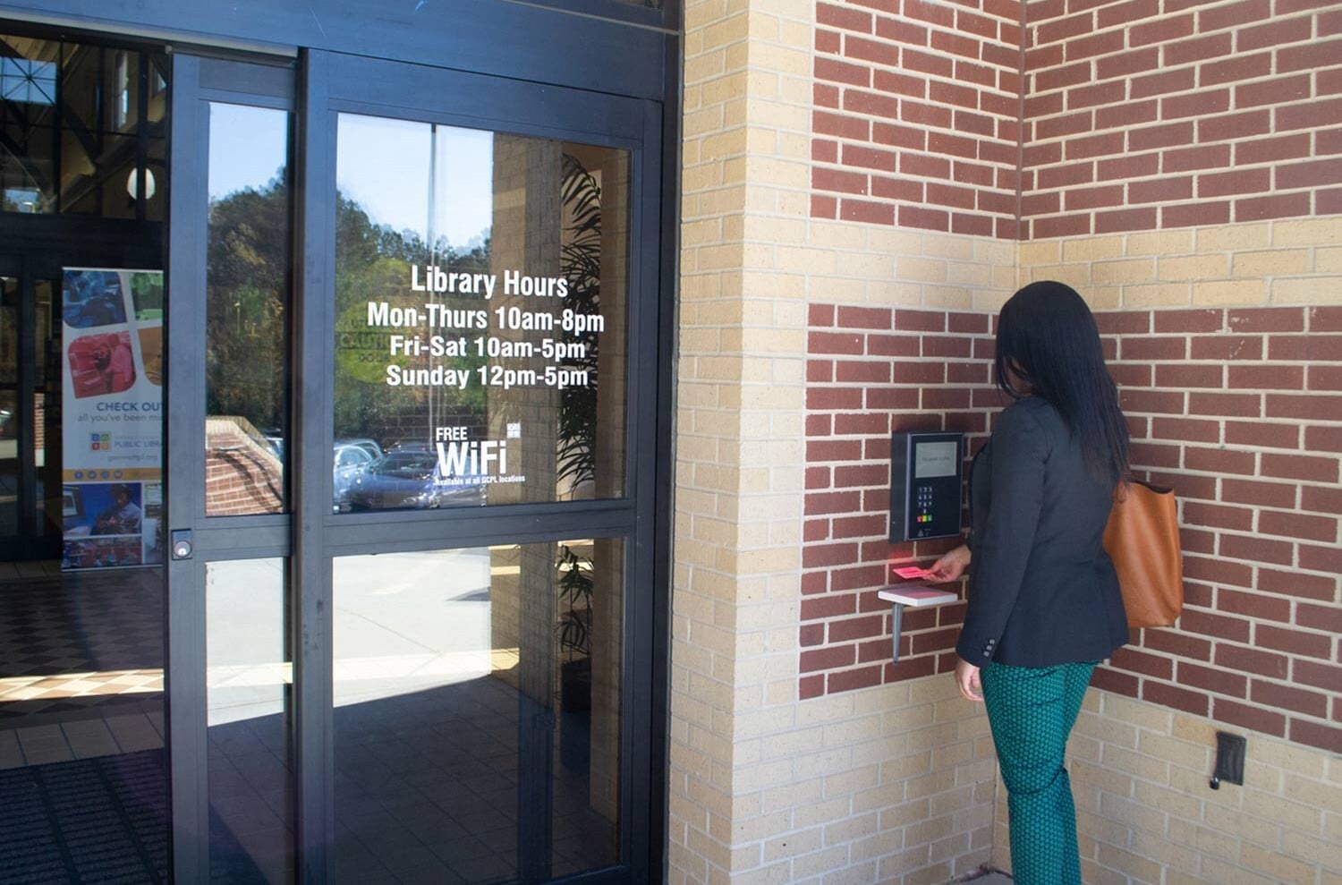 Lady using open+ access panel to enter Gwinnett County Public library-1