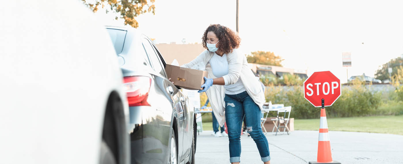 iStock-1282319752-Lady handing over click and collect package