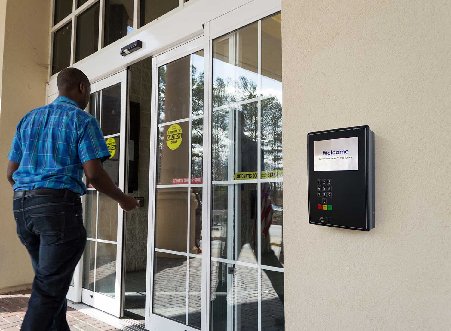 Man entering library with access control panel