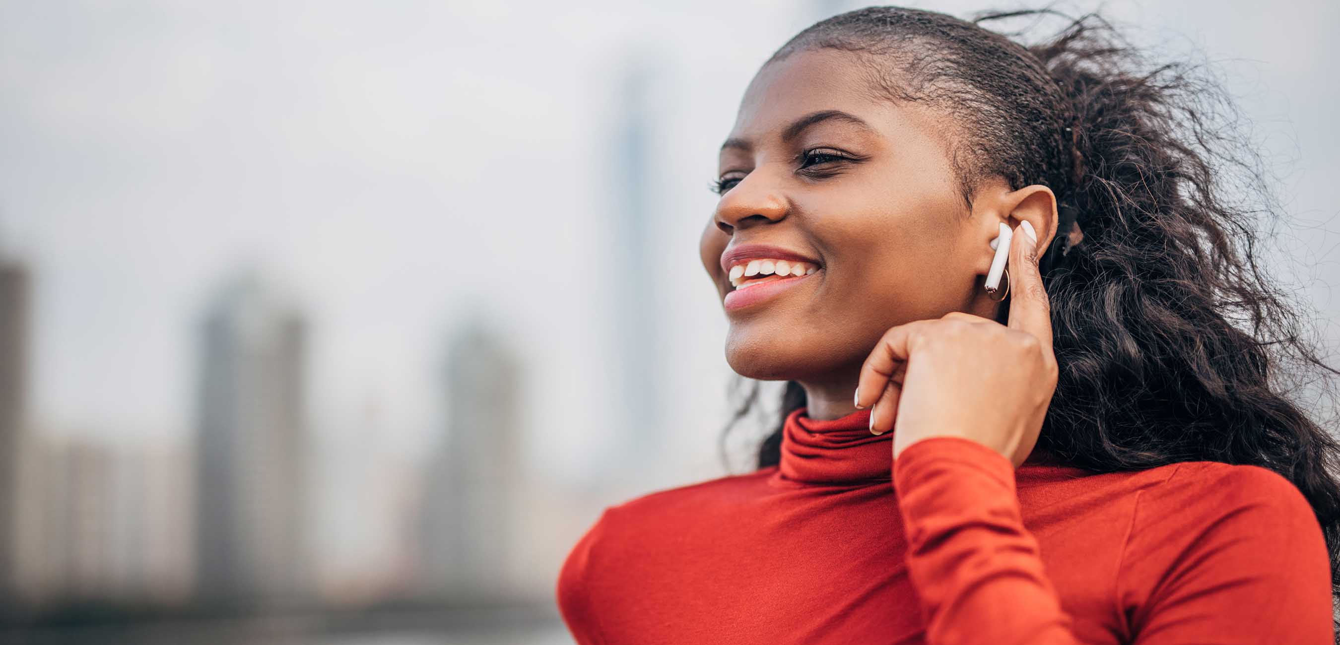 iStock-1244934122 woman listening to apple airpods